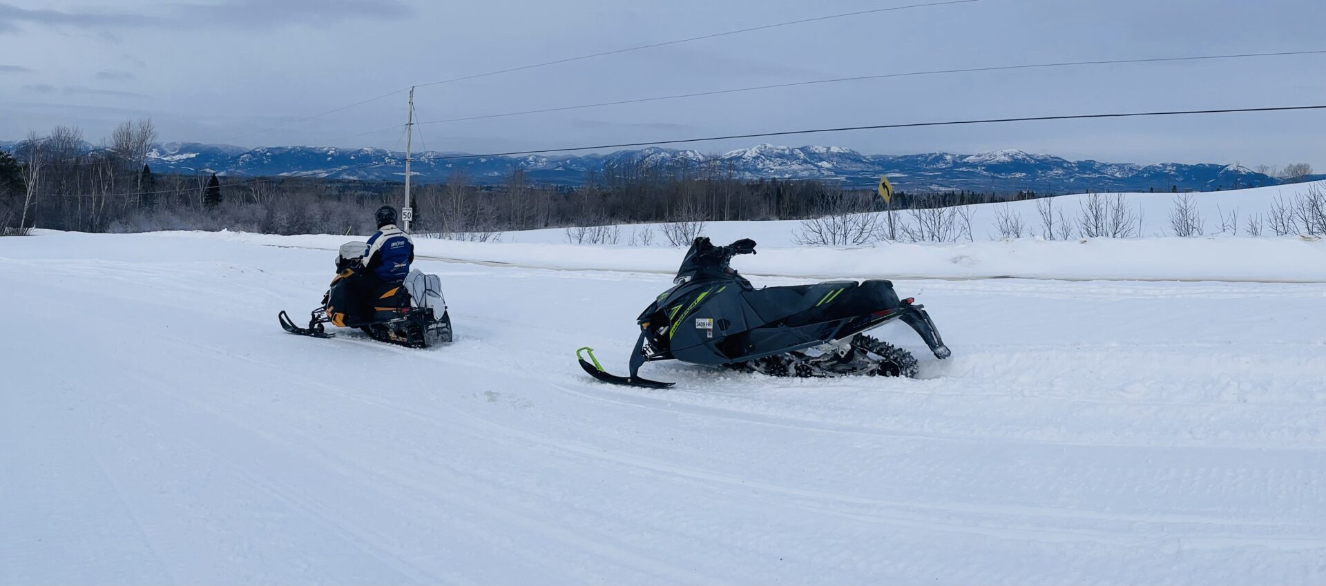 A person on a snow mobile in the snow.